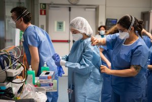 Hospital workers in blue dress in PPE