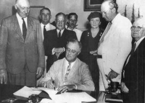 The 1935 Wagner Act (The National Labor Relations Act): Among other things, this federal law, enacted by President Franklin Delano Roosevelt as part of his New Deal, protected private sector workers’ rights to form unions and bargain collectively. But it excluded public sector workers—along with agricultural and domestic workers—from its provisions. Franklin Roosevelt signs the Social Security Act, which represented a key part of Roosevelt’s “New Deal,” as was the Wagner Act.