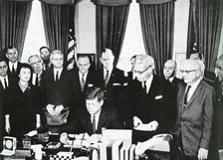 In 1959, Wisconsin became the first state to pass a collective bargaining law for its public employees, largely thanks to significant lobbying from the American Federation of State, County, and Municipal Employees (AFSCME). In 1962, President John F. Kennedy passed his Executive Order 10988, which granted many federal employees limited collective bargaining rights. President Kennedy signing EO 10988. Credit: NALC 