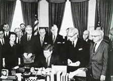 In 1959, Wisconsin became the first state to pass a collective bargaining law for its public employees, largely thanks to significant lobbying from the American Federation of State, County, and Municipal Employees (AFSCME). In 1962, President John F. Kennedy passed his Executive Order 10988, which granted many federal employees limited collective bargaining rights. President Kennedy signing EO 10988. Credit: NALC